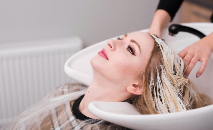 Woman getting her hair washed at a salon