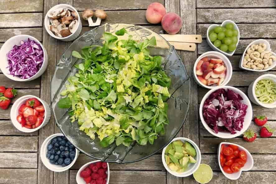 Small bowls of fruit and vegetables arranged in circular fashion