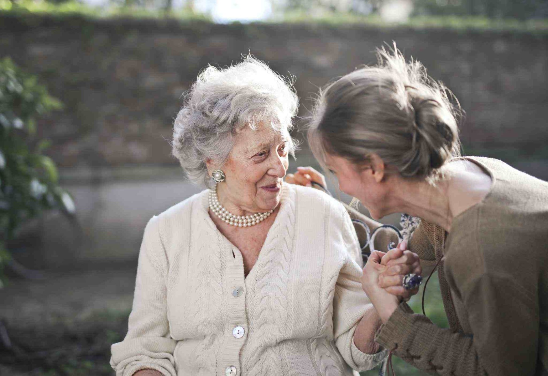 Two old woman sat down chatting