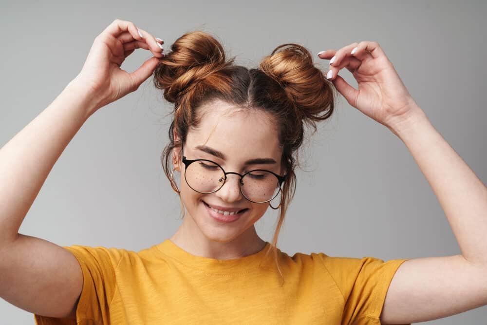 Woman playing with her protective updos hairstyle