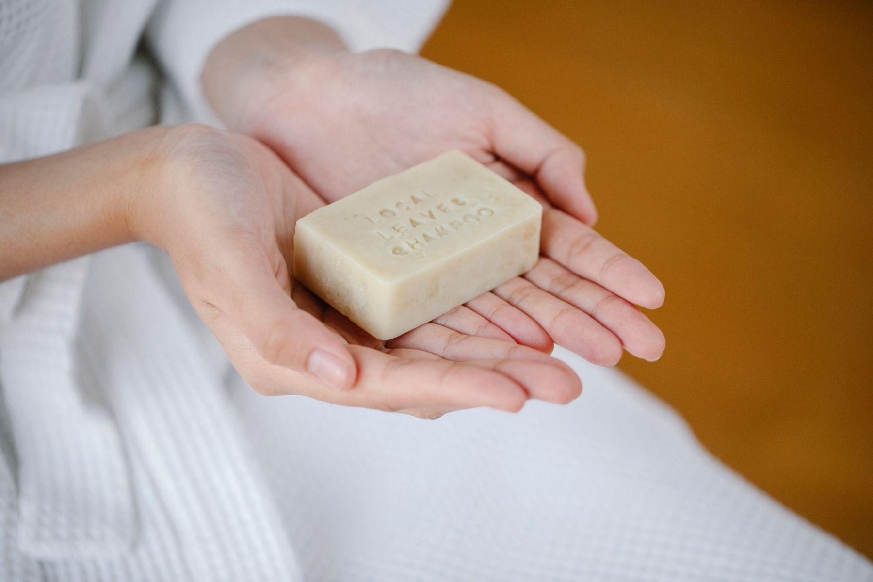 Woman holding a shampoo bar in her hand
