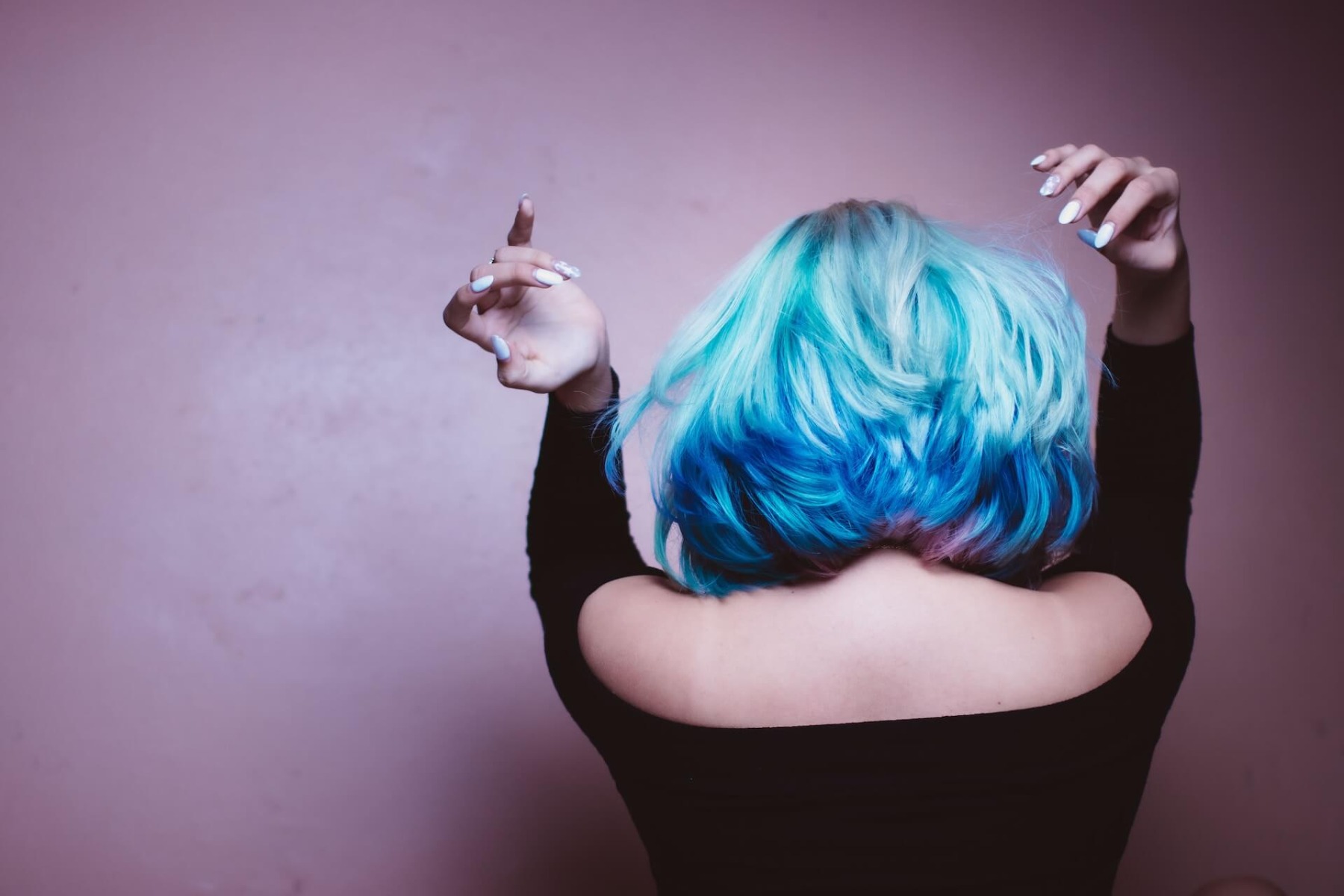 Woman with a blue wig secured to her head