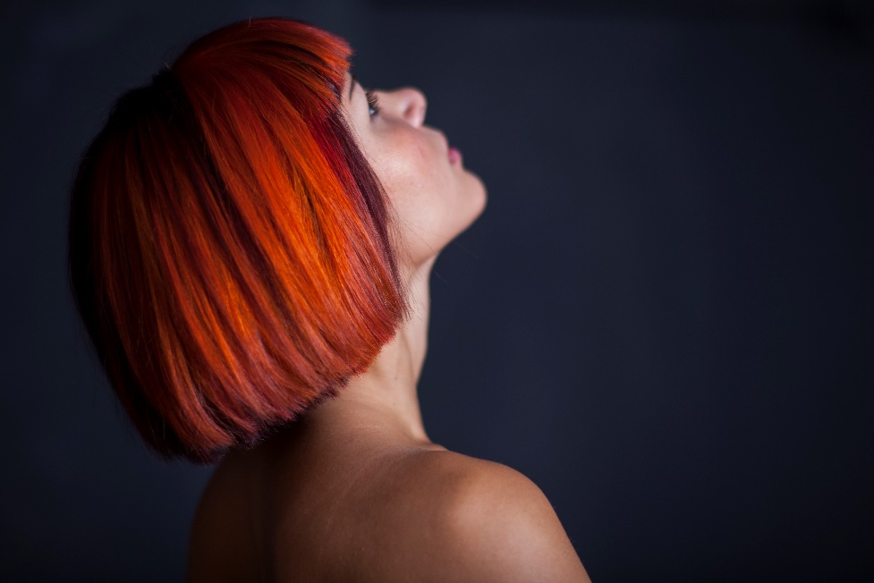 Head of woman with dyed bob hairstyle looking upwards