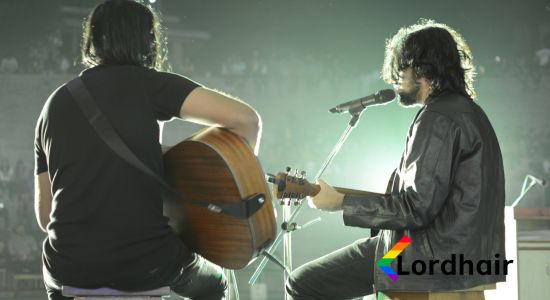 Two guitarists performing at a concert